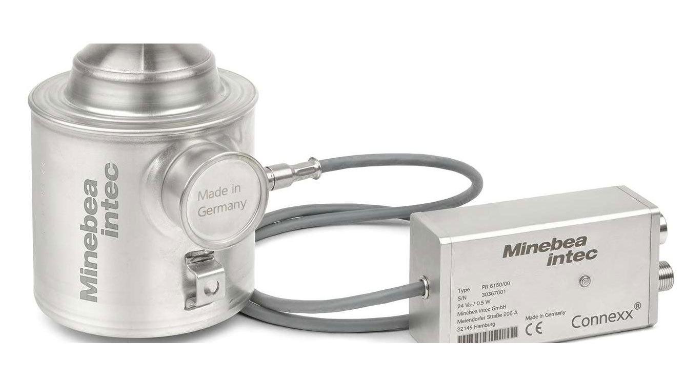 Billede af en Minebea Intec måleenhed med en sølvfarvet sensor og tilslutningskabel.