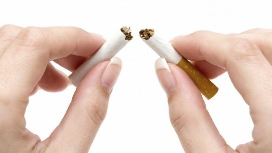 Hænder der knækker en cigaret i to, symboliserer opgivelse af rygning og sund livsstil.