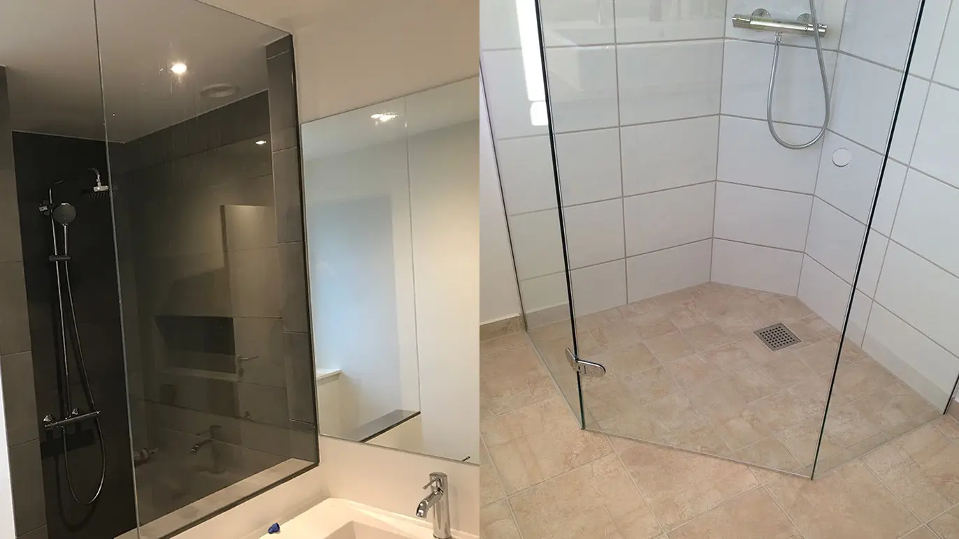 Moderne badeværelse med glasbruser og spejl, der viser en ren og stilfuld indretning.