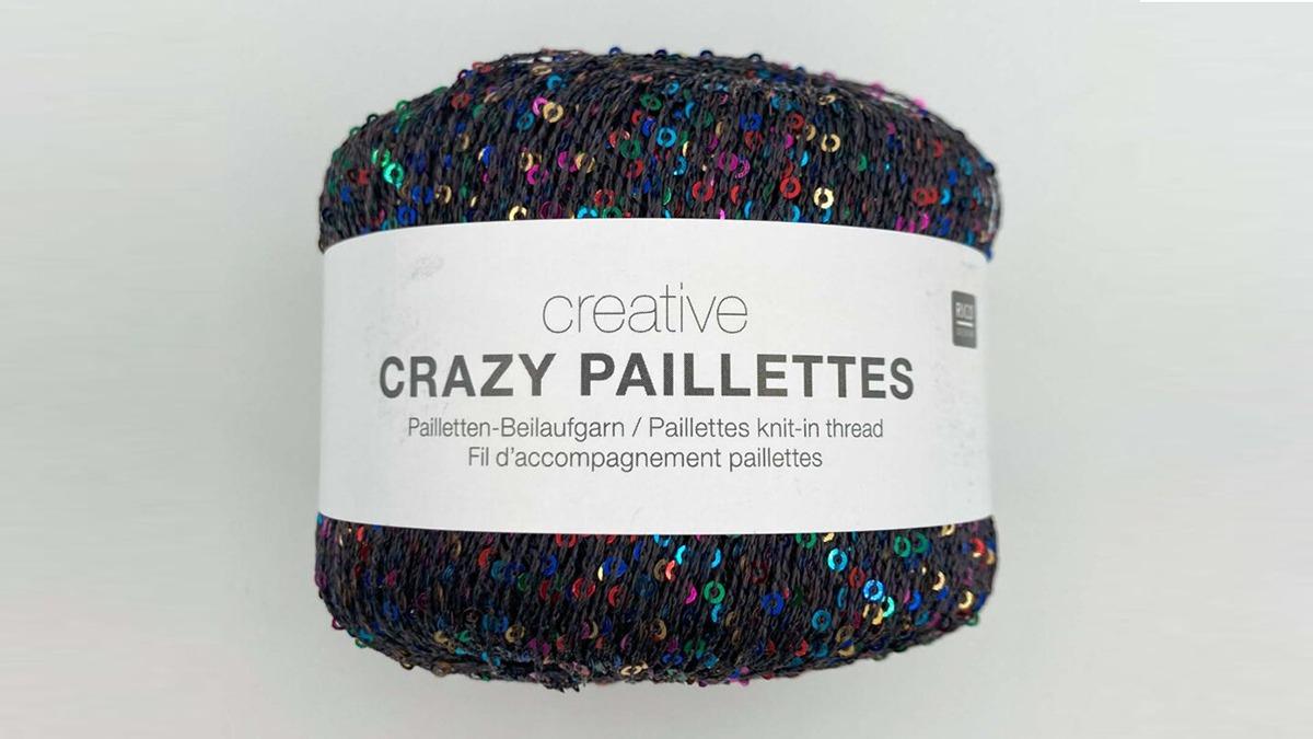 En garnnøgle med navnet "Crazy Paillettes" fra Creative, dækket af glitrende pailletter i forskellige farver.