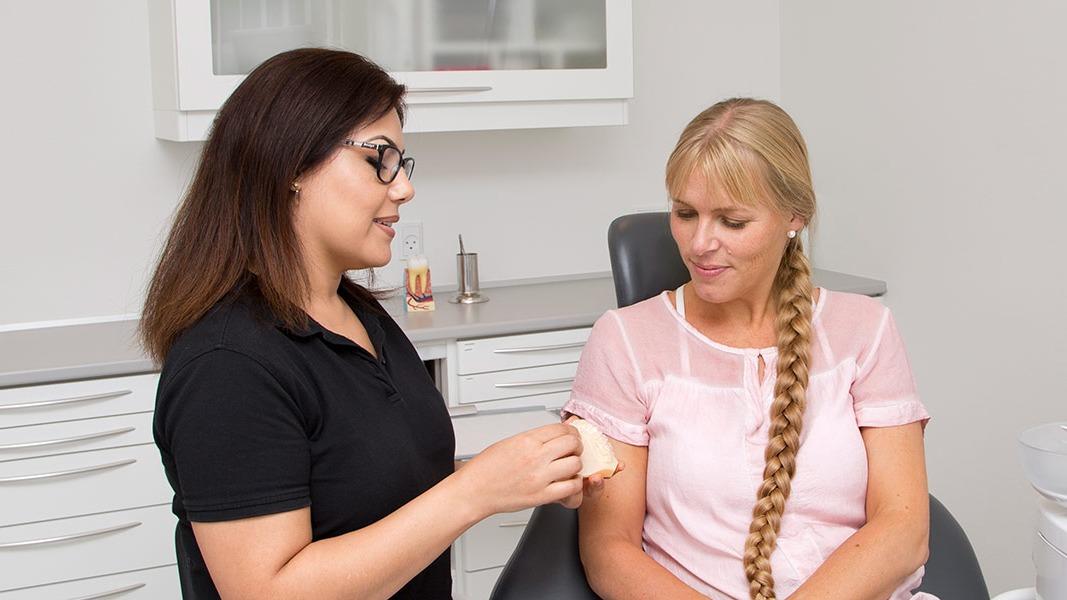 En kvinde får rådgivning om skønhedsbehandlinger af en professionel i en klinik.
