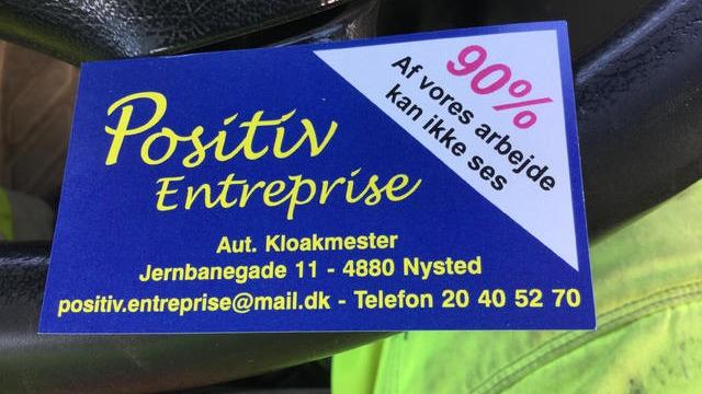 Visiting card for Positiv Entreprise with contact details and a note about 90% usynligt arbejde.